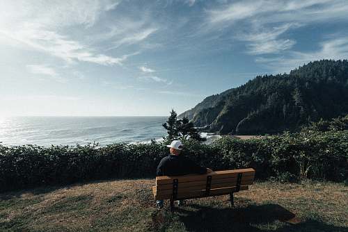 bench man sitting on bench with mountain background oregon